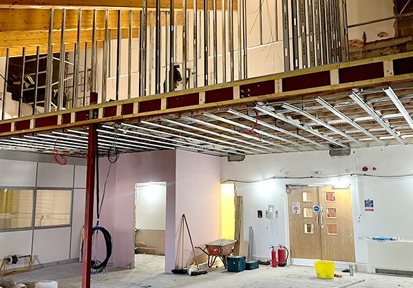 New Start Homes Liverpool office mezzanine construction showing steel framework and ceiling installation
