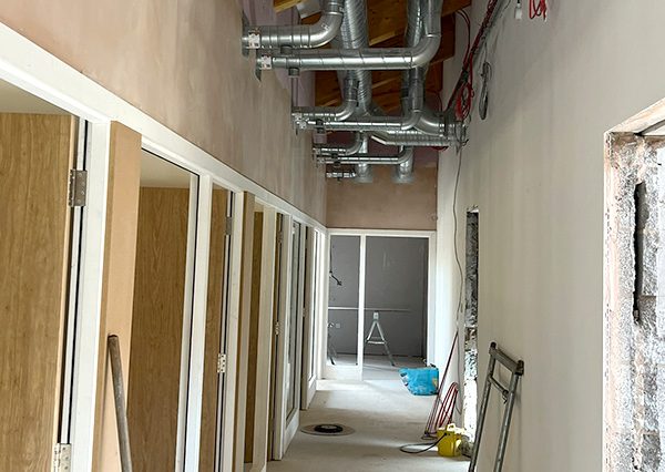 New Start Homes Liverpool office interior construction showing partition walls and mechanical services