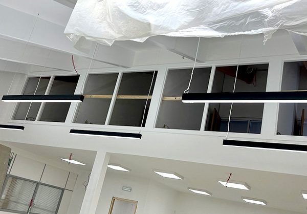 New Start Homes Liverpool office mezzanine glazing installation showing glass panels and balustrade work